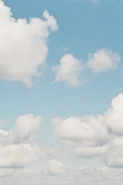 Light blue sky with white clouds.